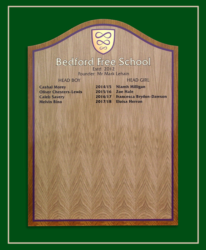 An light oak honours board in two shades of wood colour.
