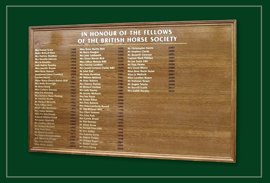 A large equestrian oak framed honours board with gold and black lettering