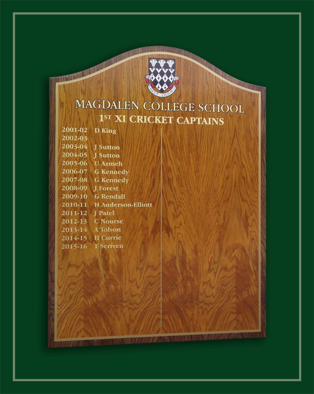 An oak veneered honours board listing the cricket captains of Magdalen College School