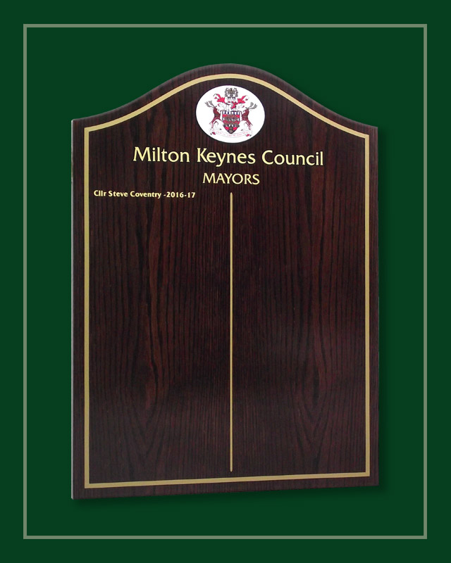 Dark oak honours listing the names of Milton Keynes mayors.